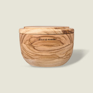 The Portobello Olive Wood Salt Cellar by Cole & Mason features natural grain patterns, a matching lid, and the brand logo on the front, adding timeless charm to your kitchen decor. Shown against a plain light background.