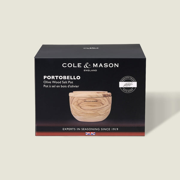 A Cole & Mason box displays the Portobello Olive Wood Salt Cellar—a small, round wooden container with a lid. The mostly black packaging features white text and a product image, making it perfect for stylish kitchen decor.