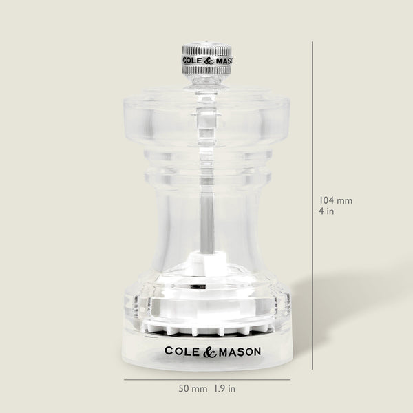 The Cole & Mason Acrylic Salt Shaker & Pepper Mill Set features a clear body with signature branding. Each adjustable grinder stands 104 mm (4 in) tall and 50 mm (1.9 in) wide, displayed against a light beige background.