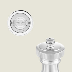 Close-up of the Hoxton Silver Plated Salt & Pepper Mill Set by Cole & Mason, showcasing detailed base labeling and an S-marked top knob for refined dining, set against a light, neutral background.