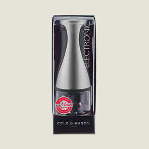 The Cole & Mason Kew Electronic 2-in-1 Duo Mill, a stainless steel salt and pepper grinder with adjustable grind settings, is shown in its original black and clear packaging with product info visible.