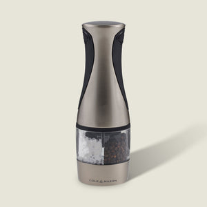 The Cole & Mason Kew Electronic 2-in-1 Duo Mill, a stainless steel and black electric grinder with a clear center for salt and pepper, features adjustable grind settings and stands upright against a light background.