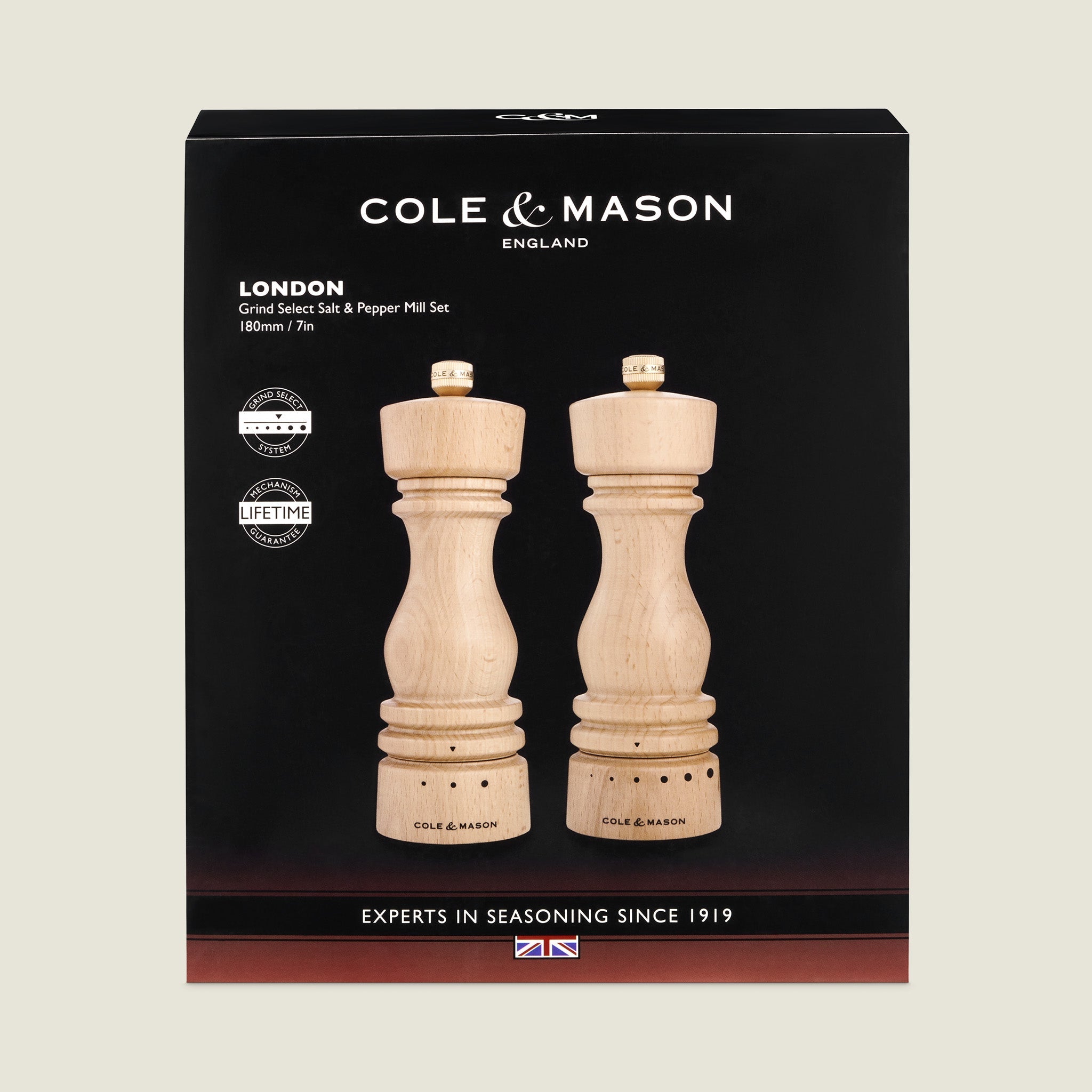 A boxed set of Cole & Mason London salt and pepper mills made of light wood, displayed in black packaging with white text and UK flag, labeled Experts in Seasoning Since 1919.